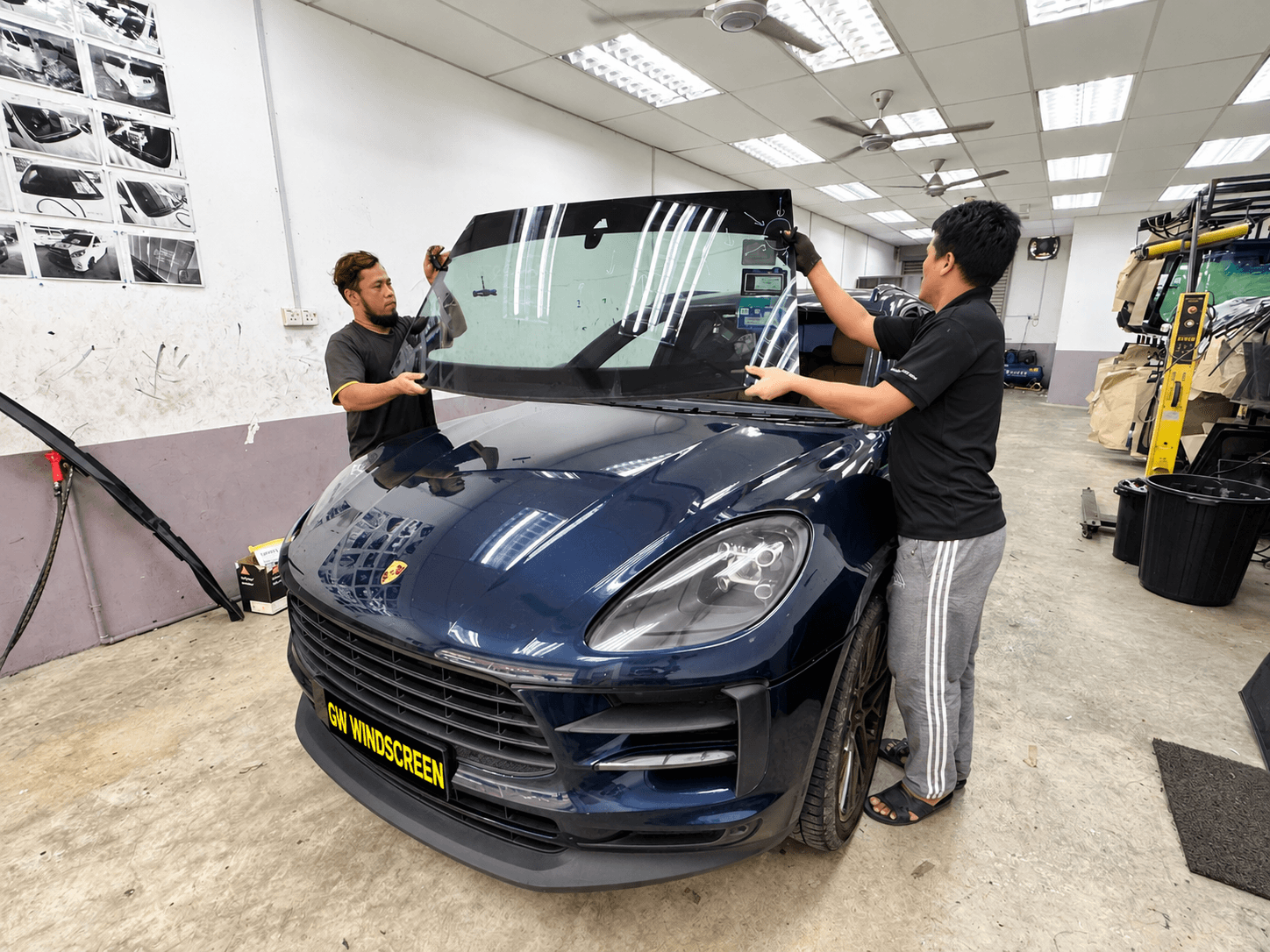Technicians replacing a car windscreen at SIFU CERMIN Senawang HQ